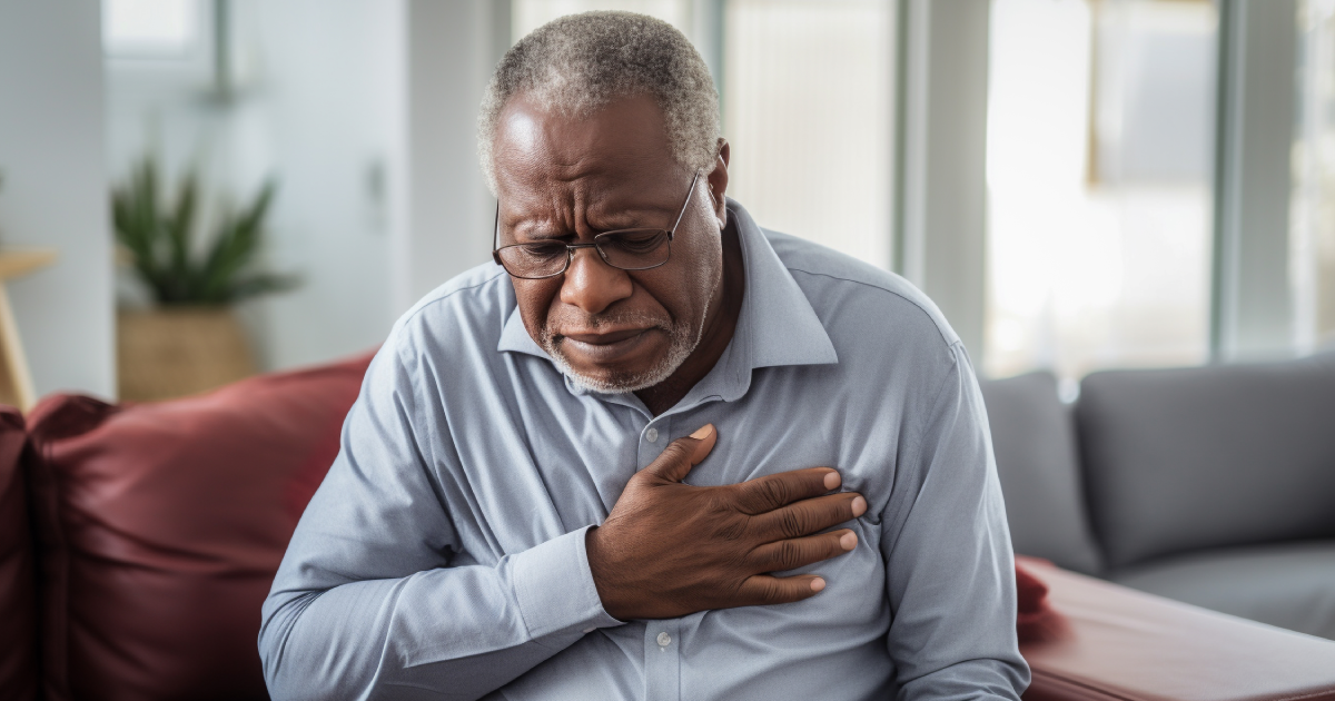 Elderly man clutching chest in pain, illustrating symptoms of cardiac amyloidosis and heart disease.